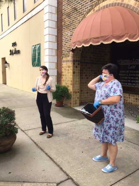 two women outside wearing face masks