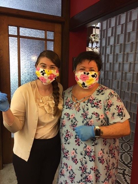 two women wearing face masks